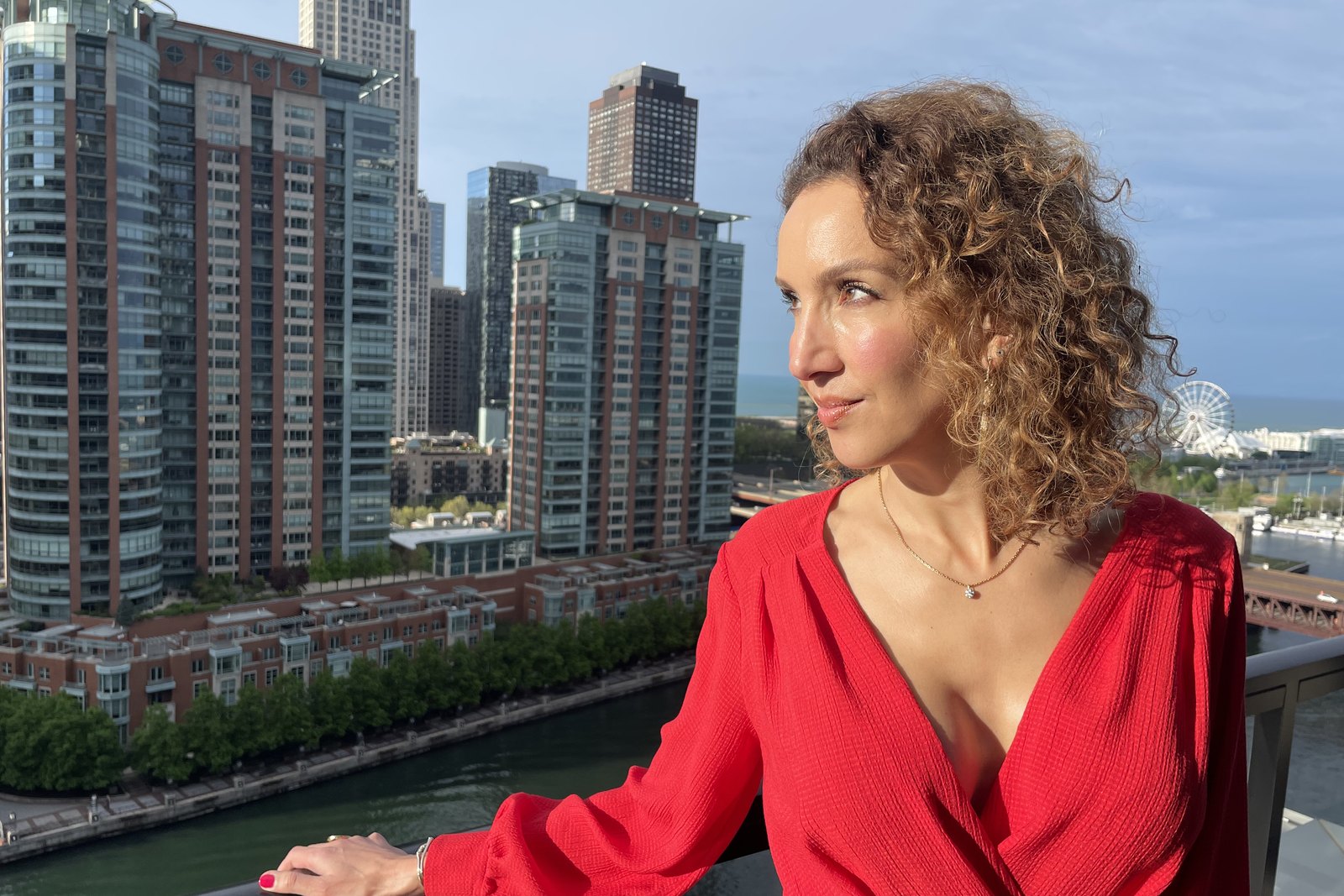 Shayda in a red dress overlooking Chicago.